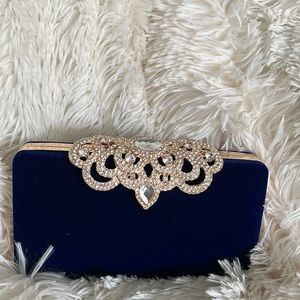Women’s Dress Clutch. Worn once. Has gold strap accessory w/rhinestone extras